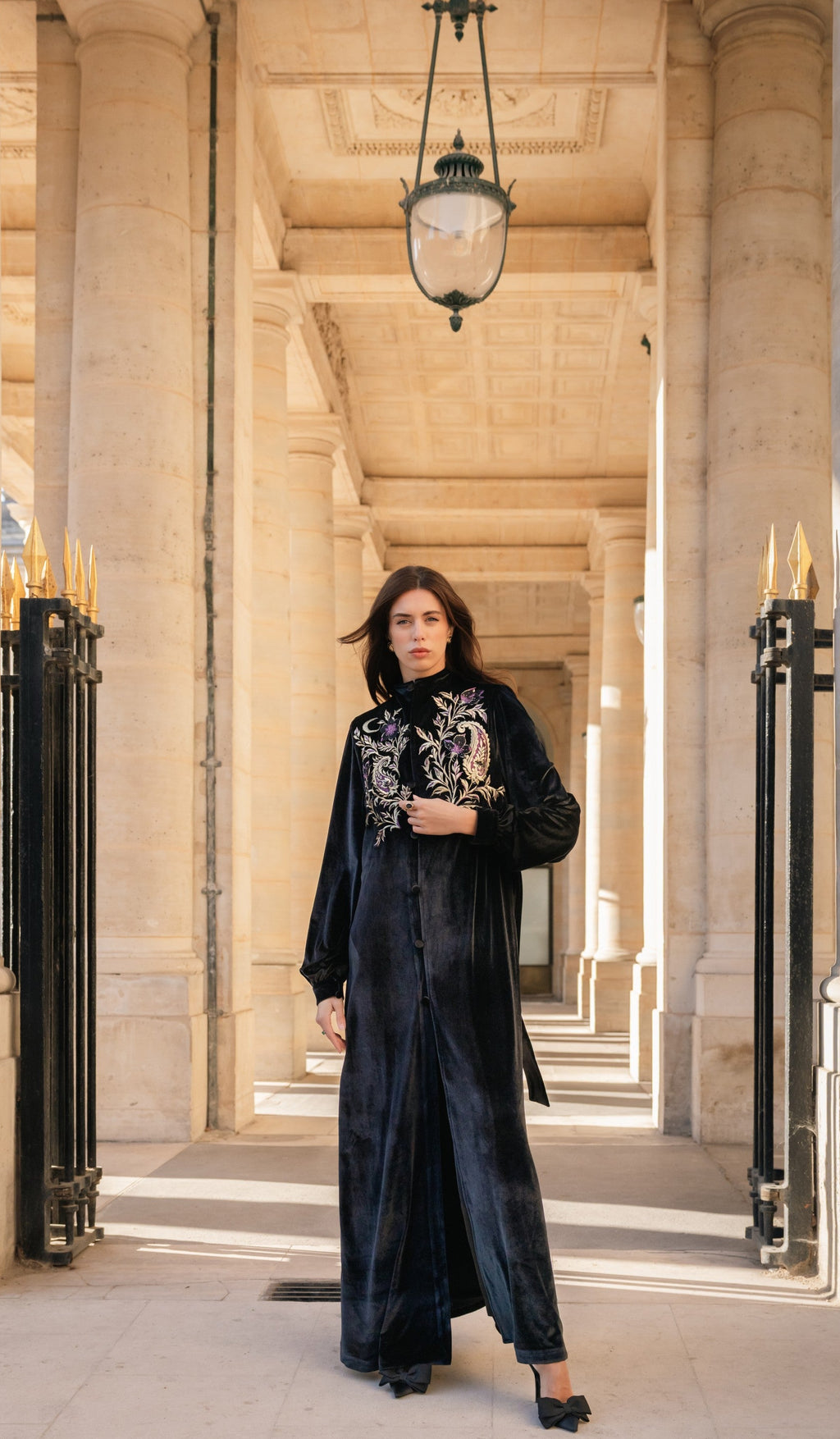 Woman in a black kimono with silk embroidery in an elegant architectural setting in Paris. 