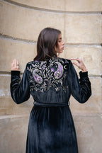 Woman wearing a black velvet abaya with intricate embroidery in Dubai. 